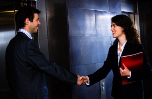 Woman greeting man by elevator